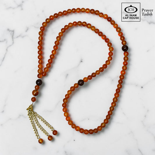 AL INAM CAP HOUSE amber and brown crystal prayer tasbih with gold chain tassel. Natural stone beads.