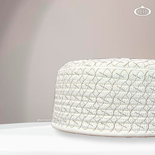 Side angle view of AL INAM ICH JJ style cream and brown embroidered Namazi topi with premium quilted stitching