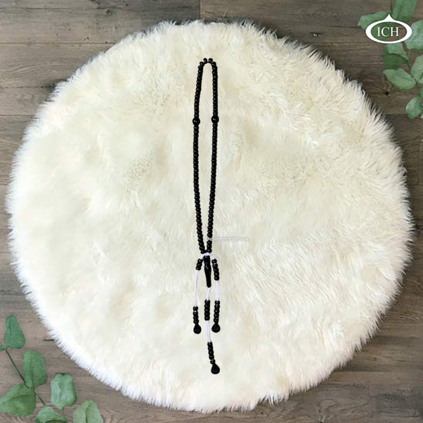 Black Islamic prayer beads Al Inam Tasbih – misbaha for dhikr and remembrance of Allah on white fur background