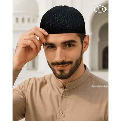 N06 black, Islamic prayer cap, angled view on model, elegant textured design, comfortable fit, AL INAM CAP HOUSE