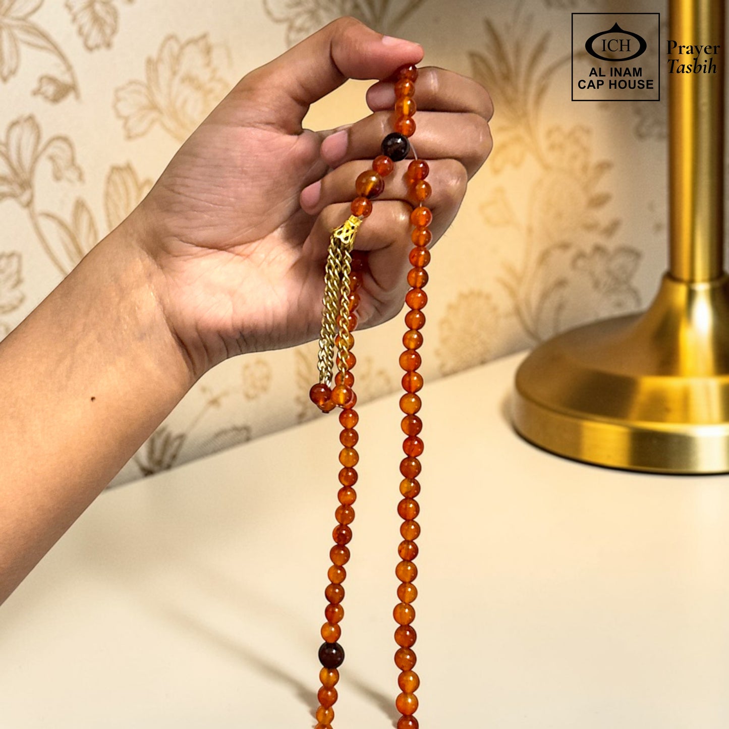 AL INAM CAP HOUSE amber and brown crystal tasbih prayer beads with gold tassel detail.