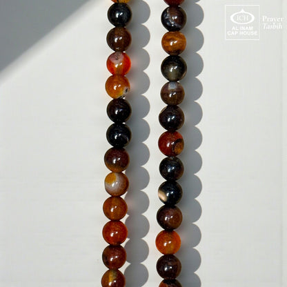AL INAM CAP HOUSE Belgium Crystal Tasbih with amber, brown, orange, black, and milky beads. Smooth, polished, and translucent.