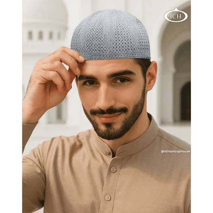 N07 grey, Islamic prayer cap, angled view on model, elegant design, comfortable fit, AL INAM CAP HOUSE