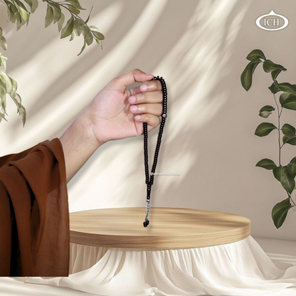 Al Inam dark brown Islamic prayer tasbih in hand – high-quality misbaha for dhikr and remembrance of Allah, Muslim gift.