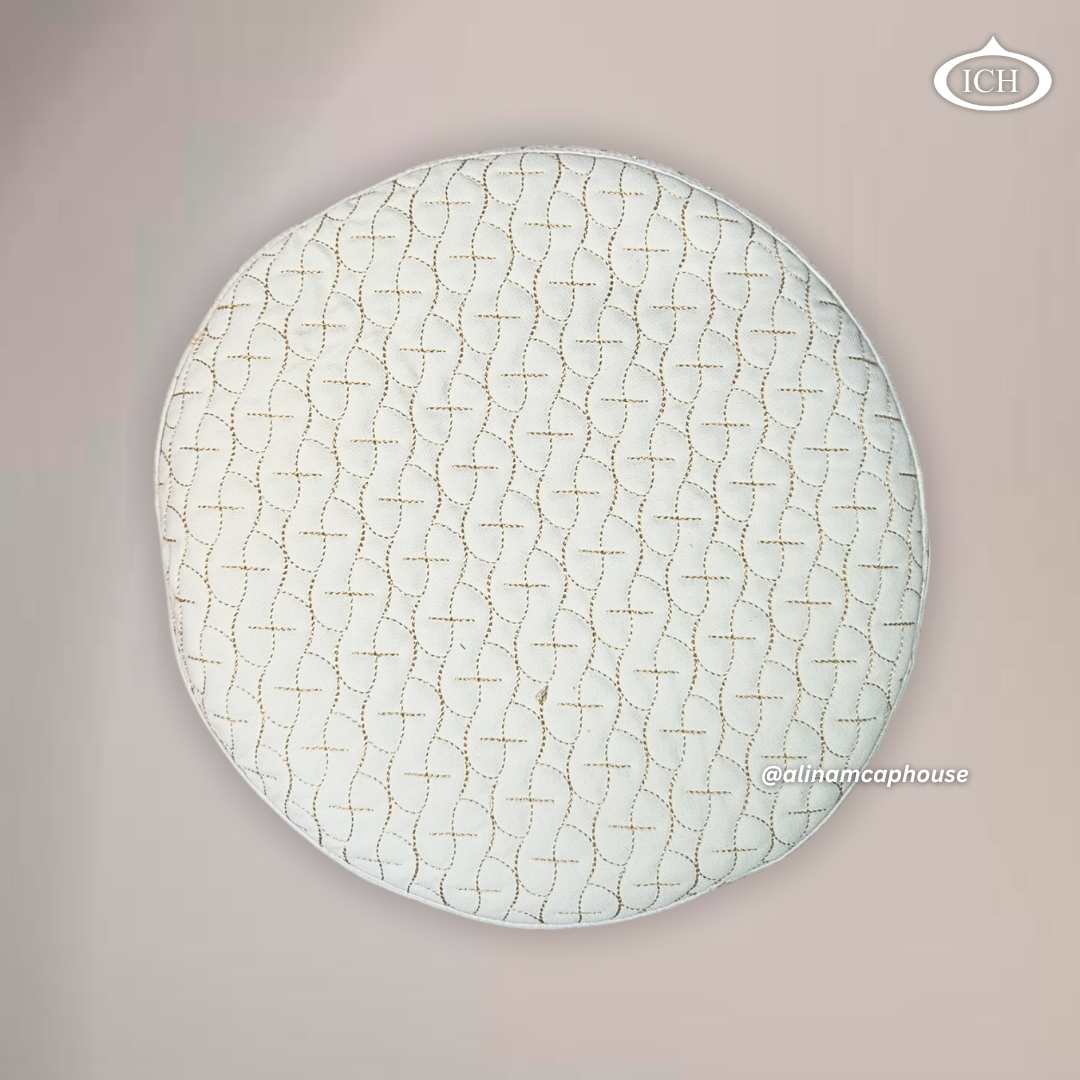 Top view of AL INAM ICH JJ style Islamic prayer cap showing detailed golden embroidery on cream fabric