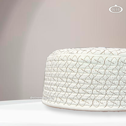 Side angle view of AL INAM ICH JJ style cream and brown embroidered Namazi topi with premium quilted stitching