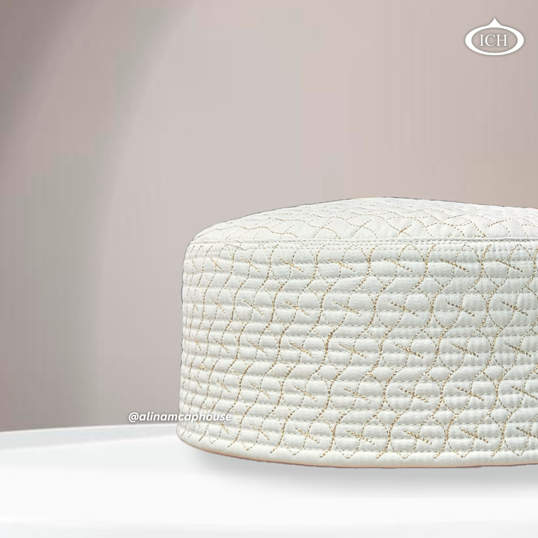 Side angle view of AL INAM ICH JJ style cream and golden embroidered Namazi topi with quilted stitching