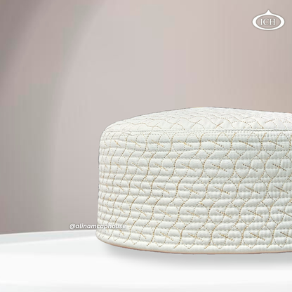 Side angle view of AL INAM ICH JJ style cream and golden embroidered Namazi topi with quilted stitching