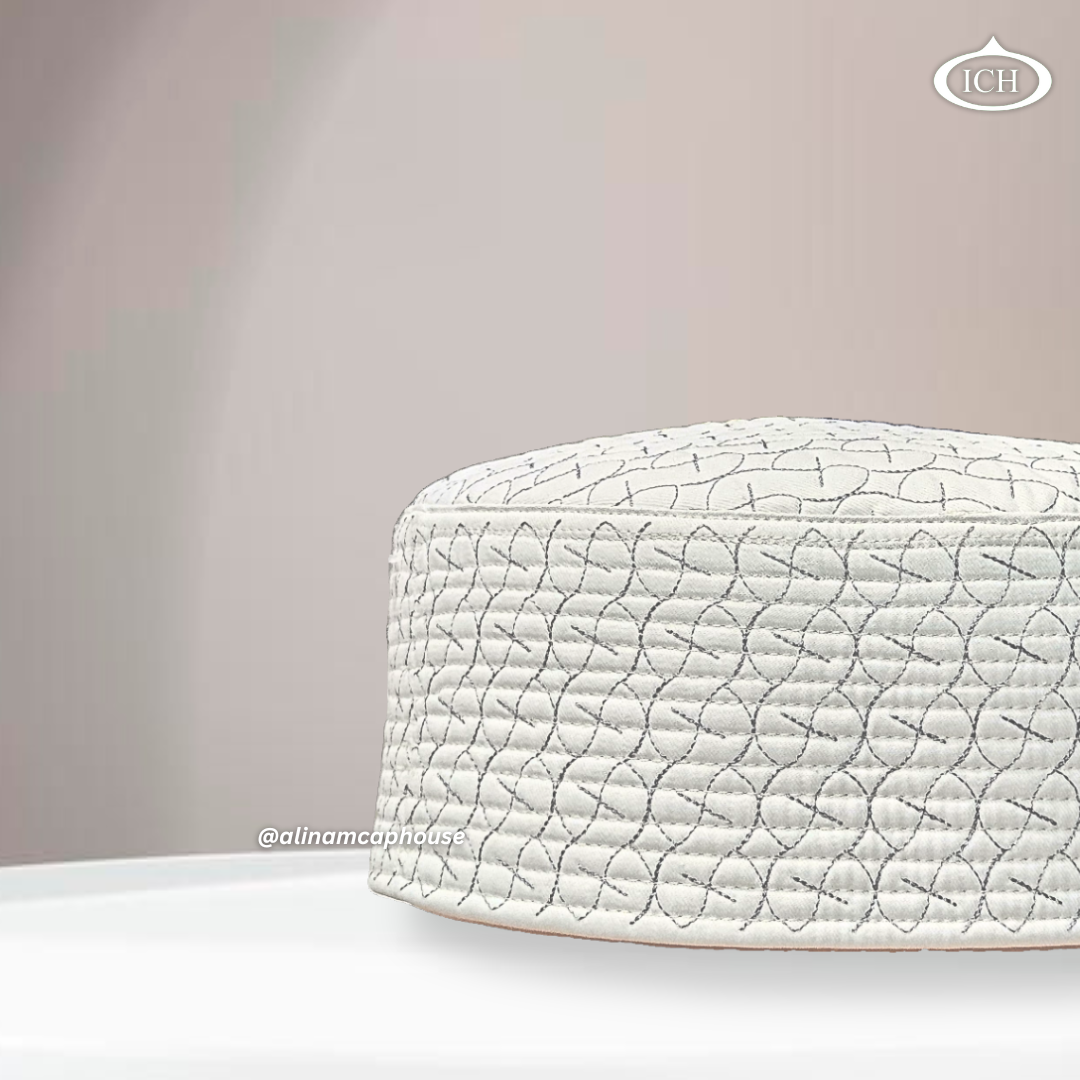 Side angle view of AL INAM ICH JJ style embroidered Namazi topi in cream and grey with premium quilted stitching