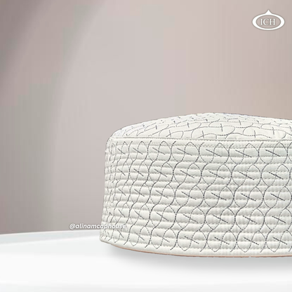 Side angle view of AL INAM ICH JJ style embroidered Namazi topi in cream and grey with premium quilted stitching