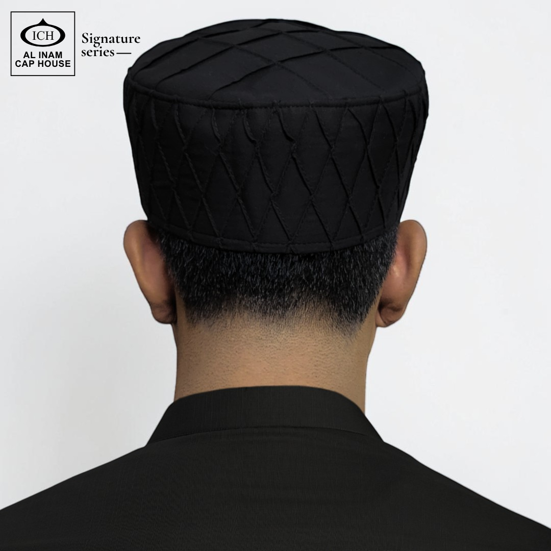 Model view of AL INAM black Islamic prayer cap showing comfortable fitting and stylish traditional Muslim skull cap appearance.