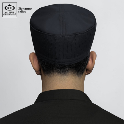Back worn view of AL INAM Signature Islamic Prayer Cap on model showing proper head fit, secure hold and traditional kufi look for Muslim men.