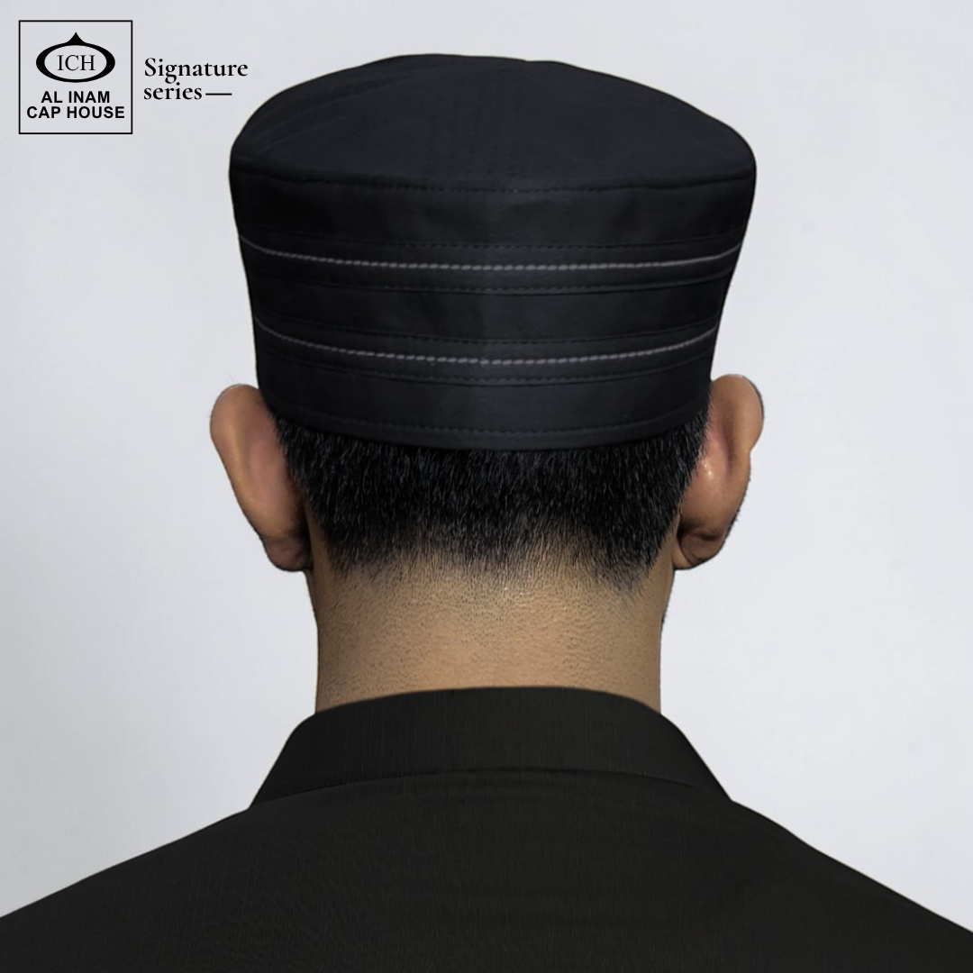 Back worn view of AL INAM Black Islamic Prayer Cap on model showing proper head fit, secure hold and traditional kufi look for Muslim men during prayer and daily wear.