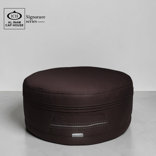 Top front view of AL INAM Brown Islamic Kufi Cap showcasing structured round shape, clean stitching and breathable fabric for comfortable and elegant prayer wear.