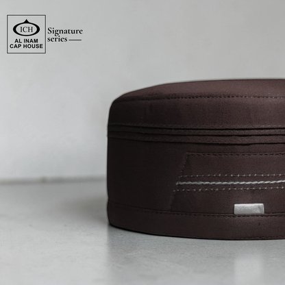 Side view of AL INAM Brown Signature Islamic Prayer Cap highlighting smooth finish, structured fit and lightweight breathable material suitable for masjid and daily use.