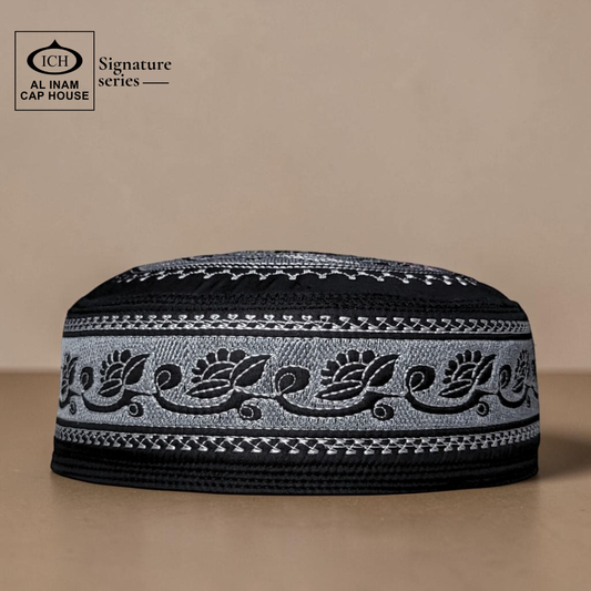 Front view of AL INAM Musqati Islamic Prayer Cap ICH-0000-A06 in black and white color combination, made with soft breathable fabric, premium kufi skull cap for Muslim men, ideal for namaz, Jummah, Eid and daily wear.