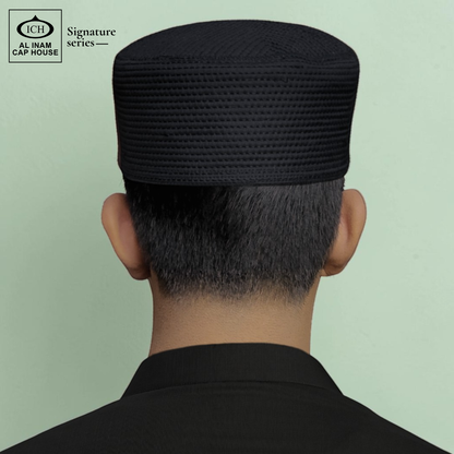 Model view of AL INAM black Islamic prayer cap showing stylish fitting, soft comfort and traditional Muslim cap appearance for everyday wear.