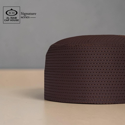 Side view of AL INAM brown Islamic kufi cap displaying breathable material and elegant traditional prayer cap craftsmanship.