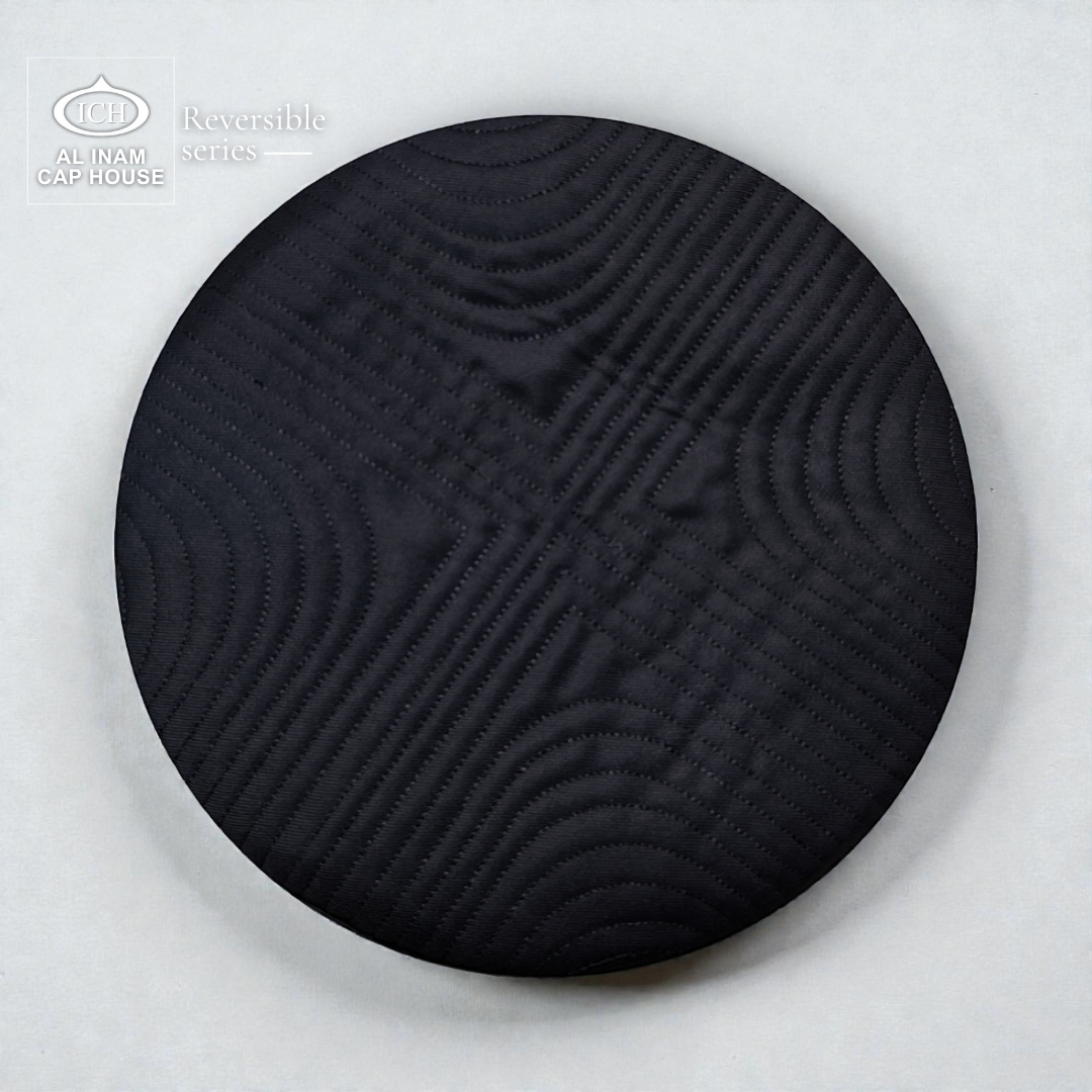 Top view of AL INAM Black Reversible Islamic Prayer Cap A-12 highlighting symmetrical embroidered craftsmanship, premium cotton fabric, reversible construction and lightweight kufi skull cap for daily Islamic wear.