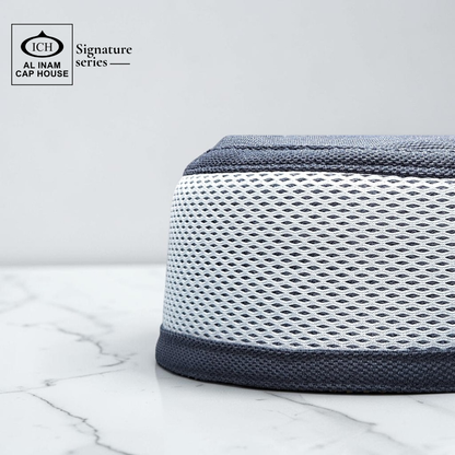 Side view of AL INAM White and Dark Gray kufi cap showing structured stretch fit and comfortable wear.