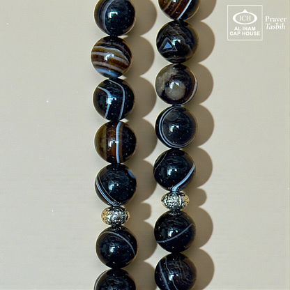 Close-up detail of AL INAM Aqeeq Hakik Tasbih highlighting natural agate stone textures, glossy polished finish and premium Islamic dhikr beads craftsmanship with unique banded patterns.
