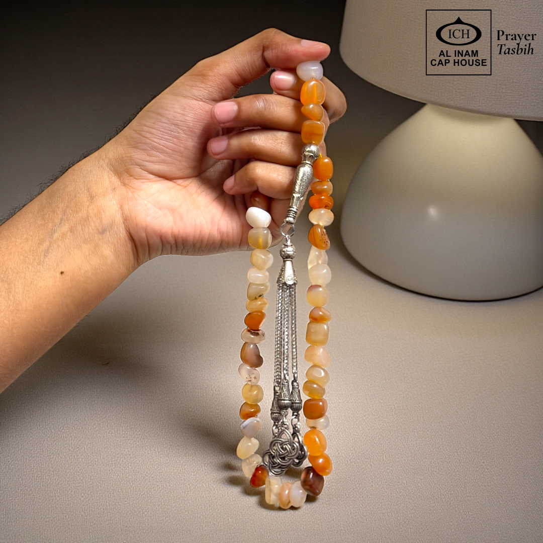 Spiritual use view of AL INAM AQEEQ Tasbih crafted with genuine agate beads and silver toned Islamic tassel, stylish zikr accessory ideal for Ramadan gifting, Eid, Hajj, Umrah and spiritual gatherings.