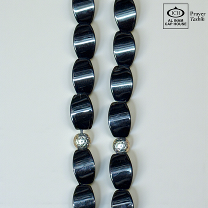 Close-up detail of AL INAM Black Aqeeq Tasbih highlighting polished natural agate stone texture, glossy black finish and premium craftsmanship Islamic dhikr beads design.