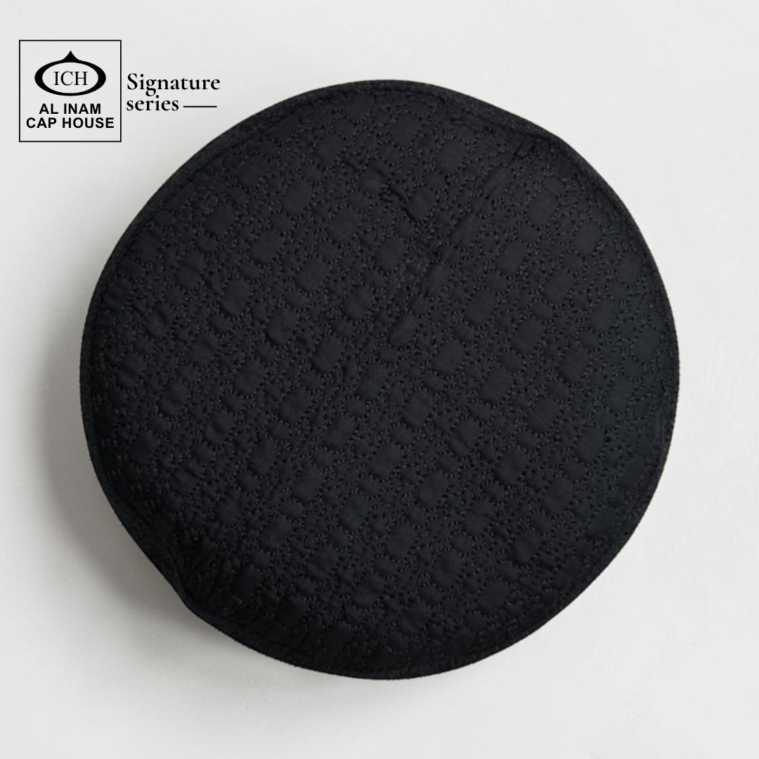Top view of AL INAM Black Islamic Prayer Cap featuring clean textured pattern, breathable cotton construction and lightweight skull cap comfort for Muslim men.