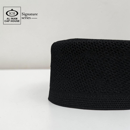 Side profile view of AL INAM Black Islamic Prayer Cap showing structured fit, clean stitching and breathable cotton material for comfortable skull cap wear.