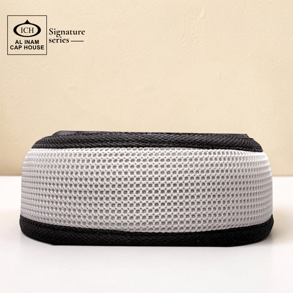 Front view of AL INAM Black and White Islamic Prayer Cap ICH-0000-A15 made with soft breathable cotton fabric, stretchable free size kufi skull cap for Muslim men, comfortable for namaz, Jummah and daily wear.