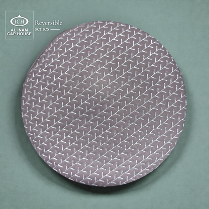 Top view of AL INAM ICH Grey Reversible Islamic Prayer Cap displaying symmetrical geometric pattern, premium craftsmanship, breathable lightweight kufi cap for Muslim men.