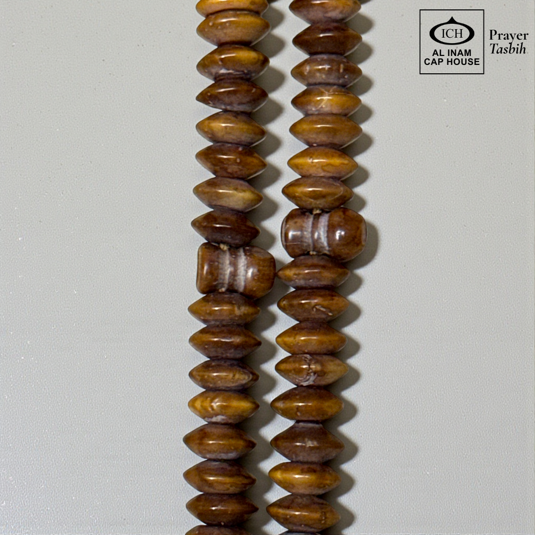 Close-up detail of AL INAM Koka Tasbih highlighting natural Kokka wood textures, polished handcrafted finish and premium Islamic dhikr beads craftsmanship with elegant grain patterns.