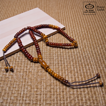 Main display view of AL INAM Koka Tasbih ICH-0000-T12 handcrafted with authentic Kokka wood beads featuring warm natural wooden tones and grain textures, premium Islamic prayer beads for dhikr, duas, Ramadan, Hajj, Umrah and daily spiritual use.