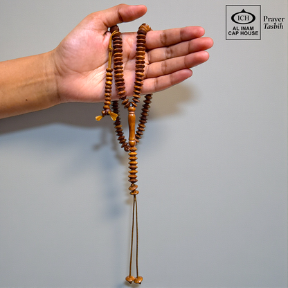 Handheld display angle of AL INAM Koka Islamic Prayer Tasbih showing lightweight balanced wooden bead arrangement, smooth comfortable grip and durable craftsmanship for daily tasbeeh recitation and duas.