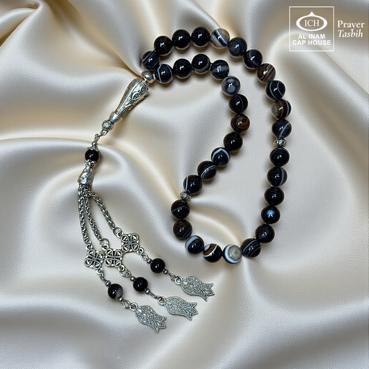 Full angle view of AL INAM Aqeeq Hakik Islamic Tasbih showcasing polished agate beads, elegant silver toned centerpiece, decorative chain tassel and traditional Muslim prayer bead craftsmanship for zikr and meditation.