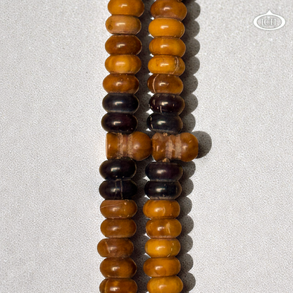 Close-up of authentic Kokka wood tasbih beads showing natural texture, rare Islamic prayer beads for dhikr.